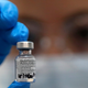 A UK nurse holds up a vial of the Pfizer-BioNTech vaccine